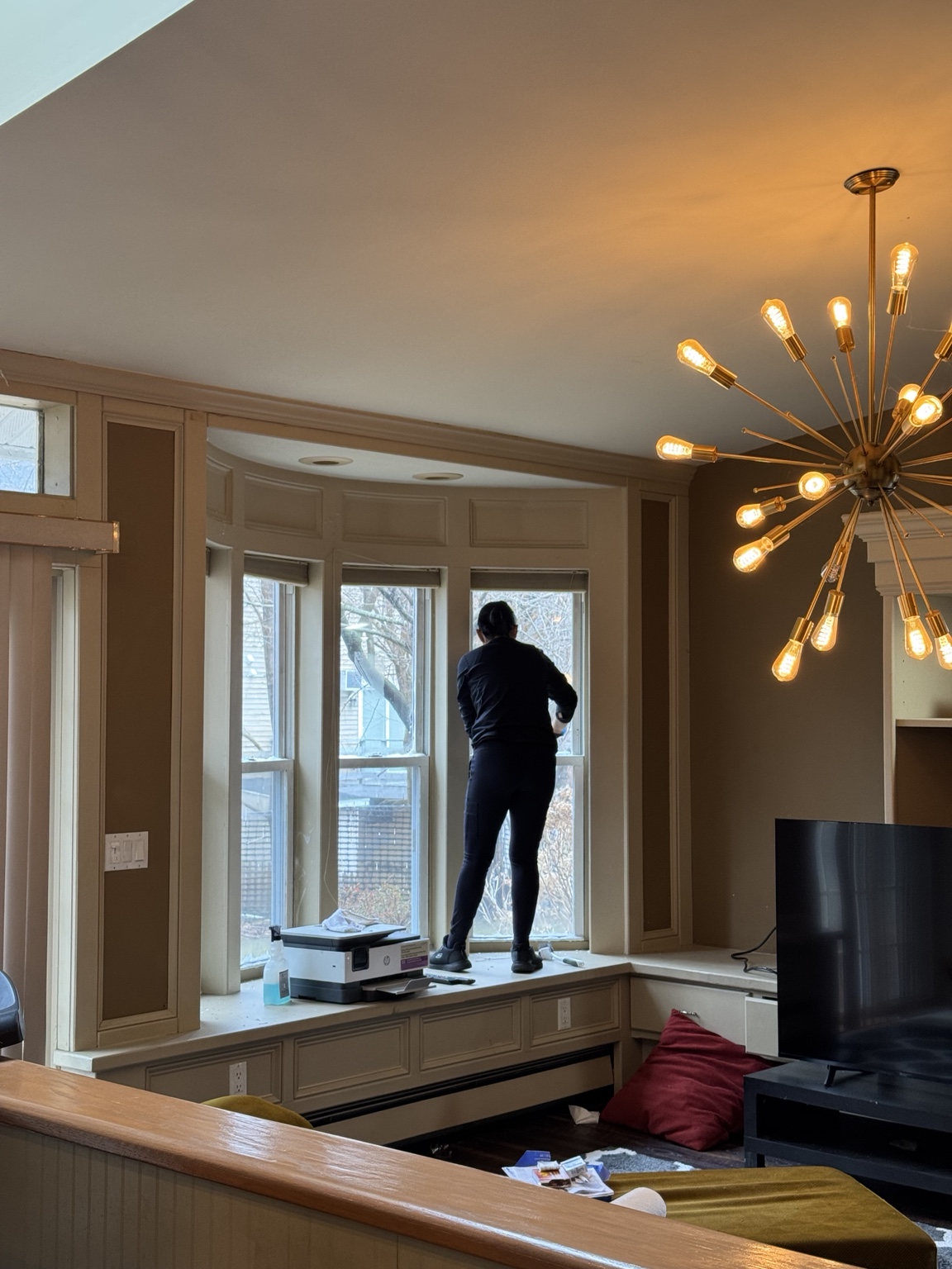 Cleazy Clean team member cleaning interior window glass in a home